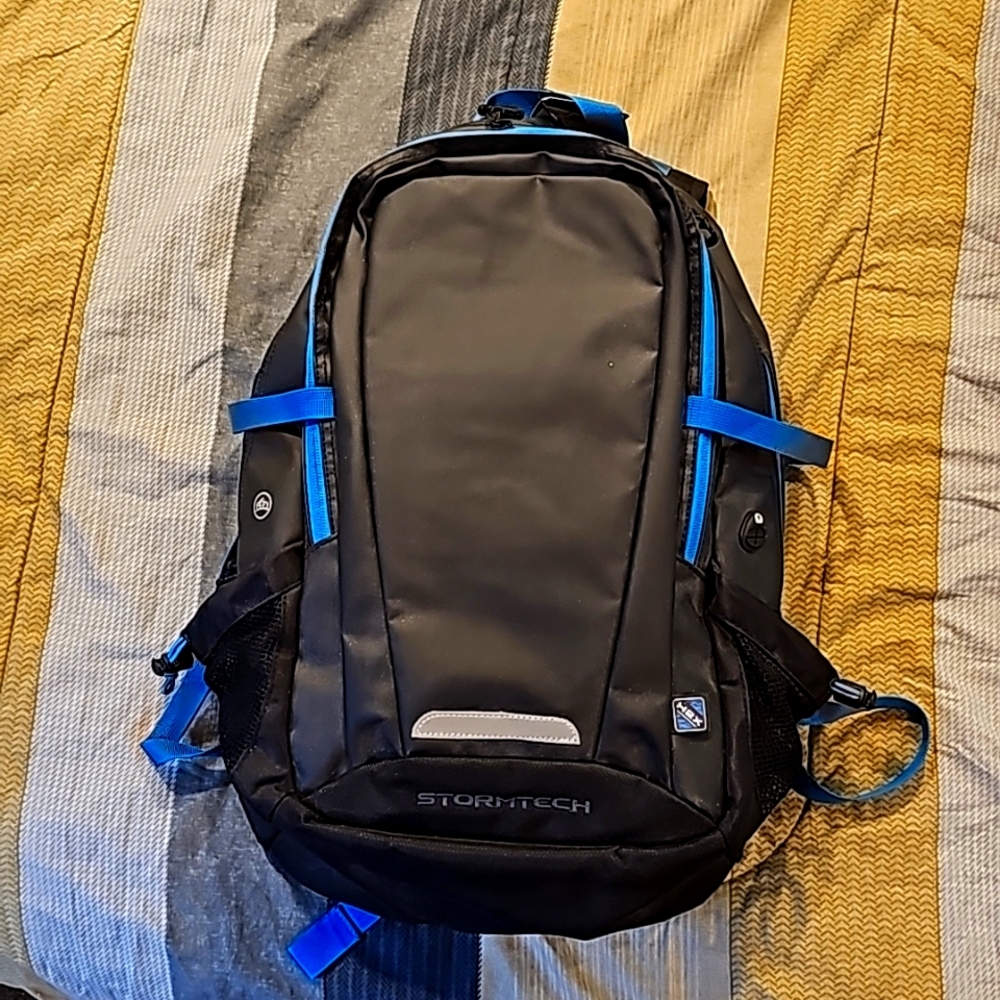 Stormtech backpack,  graphite and blue in color.